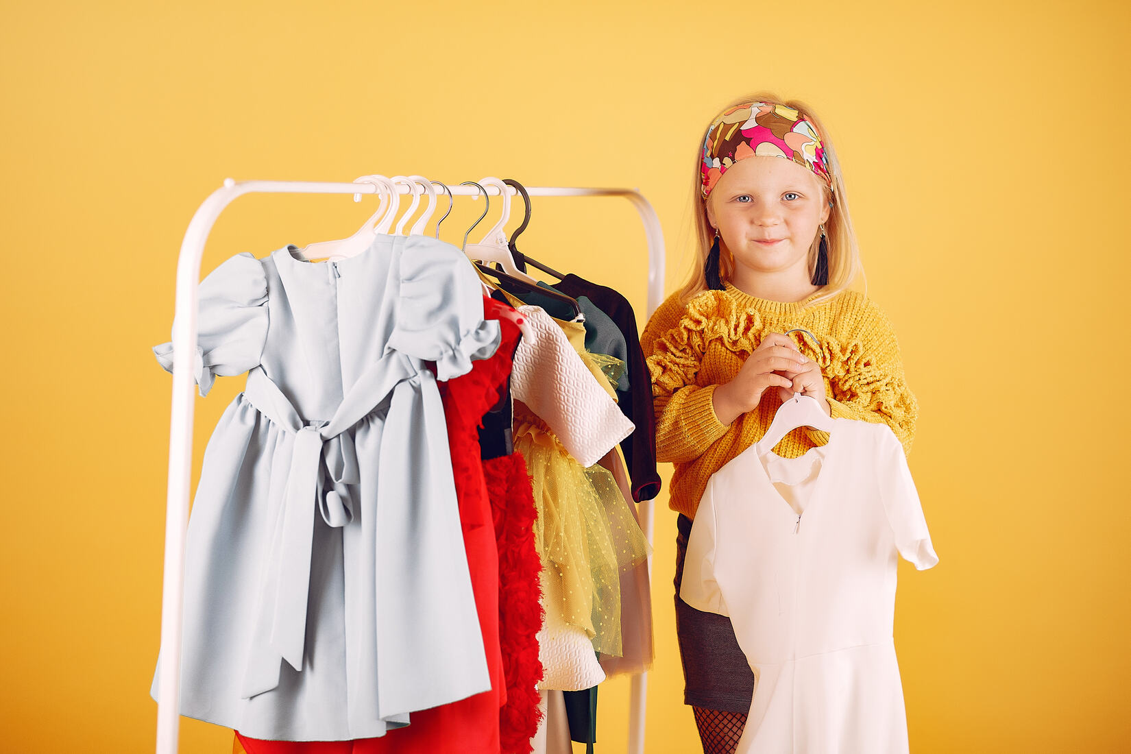 cute-little-girl-with-shopping-bags-yellow-background(1)